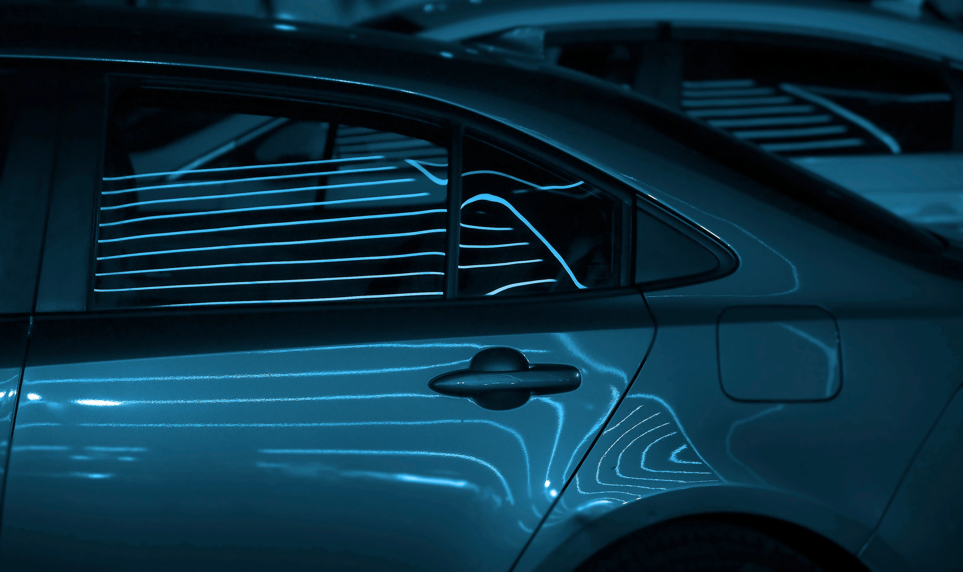 Cityscape, neon light reflection in car window.side view. Road, car window at night with driving, travel and trip for tour in city